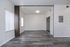 Sleek, open living space featuring elegant wood flooring, abundant natural light, and versatile design for stylish urban living.