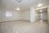 Bright, open-plan living area with sleek tiled floors and modern ceiling lights, perfect for customizable interior design.