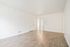Bright and airy living room with elegant wood flooring and a modern, minimalist design.
