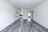 Bright and spacious open-plan living area with modern flooring and natural light flowing into the kitchen. Ideal for contemporary living.
