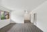 Bright and airy apartment interior with modern wood flooring and large window view.