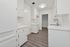 Charming kitchen with sleek white cabinets and modern lighting, ideal for culinary creativity.
