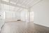 Bright and airy living space with vaulted ceilings, elegant wood flooring, and ample natural light.