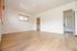 Bright and spacious room with elegant wooden flooring and a modern bathroom, perfect for a cozy and comfortable living space.