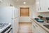 Inviting kitchen with stylish cabinetry, granite countertops, and modern appliances, featuring warm wood flooring and natural light.