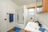 Bright and modern bathroom featuring a sleek shower, stylish vanity, and fresh decor.