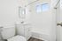 Bright and modern bathroom featuring sleek fixtures, spacious bathtub, and elegant tile accents.