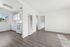 Bright and airy apartment featuring an open kitchen with white cabinets and modern flooring.