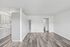 Modern open-concept living space with elegant hardwood floors and a sleek kitchen design, perfect for stylish urban living.