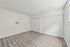 Bright, spacious room with modern wood flooring and sleek white built-in closets, perfect for a stylish and minimalist living space.
