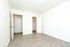 Bright, spacious room with elegant wood flooring, stylish white walls, and ample closet space for modern living.