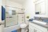 Modern bathroom with a sleek glass shower door, stylish vanity, and elegant decor.