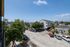 Charming urban view featuring vibrant jacaranda trees and a cozy residential neighborhood under a clear blue sky.