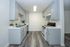 Charming kitchen with modern grey cabinetry, sleek countertops, and elegant flooring, ideal for culinary creativity.