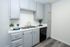 Elegant kitchen with modern gray cabinetry, stylish countertop, and sleek stainless steel sink, perfect for culinary creativity.