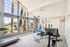 Bright and inviting home gym with modern equipment, large windows, and scenic outdoor views.