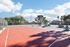 Vibrant outdoor sports courts featuring a tennis and basketball court surrounded by lush greenery and scenic views, perfect for active living.