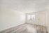 Bright and inviting living space with elegant light wood flooring and ample natural light through wide windows.