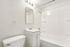 Bright, modern bathroom featuring sleek fixtures, a clean vanity, and a pristine bathtub.