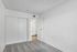 Bright, cozy bedroom with modern sliding closet doors and soft carpet flooring, offering a tranquil retreat.