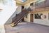 Inviting apartment exterior featuring a bright courtyard, elegant stairs, and charming second-floor balcony.