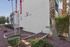 Modern, upscale apartment complex exterior with neatly manicured landscaping and red flags at The Villas.
