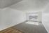 Bright and spacious living room with large windows and plush carpeting, offering an inviting and open atmosphere.