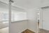 Bright and inviting apartment interior showcasing a spacious living area with natural light pouring through large windows.