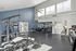 Bright and spacious fitness center with modern gym equipment and large windows for natural light.