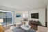 Chic modern living room with cozy seating and stylish dining area, boasting natural light and sleek decor.