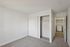 Bright and airy bedroom with modern closet space and convenient access to a laundry room.