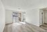 Bright and airy living space with modern wood flooring and large sliding glass doors leading to a charming balcony.