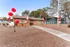 Charming apartment entrance with vibrant red and white balloons, set against a beautifully landscaped desert garden.