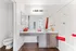 Modern bathroom with sleek fixtures, elegant countertop, and vibrant red accents, creating a stylish and inviting space.