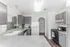 Modern kitchen with sleek gray cabinets, granite countertops, and stainless steel appliances, perfect for culinary enthusiasts.