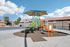 Charming community playground with colorful slides and shaded seating, surrounded by well-maintained apartments and scenic views.