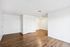 Bright and airy living space with elegant wood flooring, crisp white walls, and modern recessed lighting.