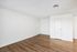 Bright, open space with modern wood flooring and fresh white walls, perfect for flexible living or office setup.