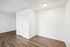 Bright entryway with sleek hardwood floors and fresh white walls, perfect for a modern touch.