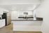 Modern kitchen with sleek stainless steel appliances and elegant white cabinetry, perfect for culinary enthusiasts.