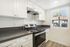 Bright modern kitchen with sleek countertops, stainless steel appliances, and ample white cabinetry offering a fresh and inviting space.