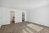 Spacious, sunlit bedroom with plush carpeting, featuring a walk-in closet and easy access to an adjacent bathroom.