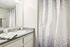 Chic bathroom with modern sink, stylish gray countertop, and contemporary geometric shower curtain.