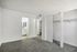 Bright and airy bedroom with plush carpet, built-in closet, and en-suite bathroom featuring modern fixtures.