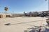 Vibrant outdoor basketball court with a sunny backdrop, ideal for sports enthusiasts, located in a modern apartment complex.