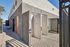 Modern outdoor shower area with sleek design and gated entry, perfect for a refreshing experience in sunny surroundings.