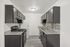 Modern kitchen with sleek dark cabinets, granite countertops, and stylish backsplash.