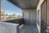 Charming balcony space with sleek walls and a contemporary door, perfect for morning coffee or unwinding outdoors.