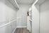 Bright and spacious storage area featuring sleek shelving and ample hanging space, perfect for organizing and maximizing functionality.