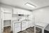 Modern kitchen with sleek white cabinetry, stylish appliances, and ample counter space, perfect for culinary creativity.